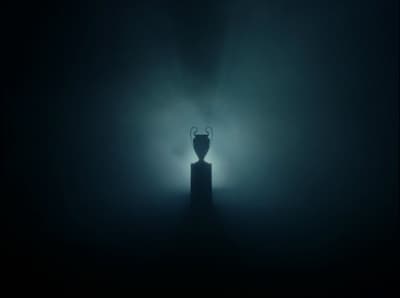 a black and white photo of a candle in the dark