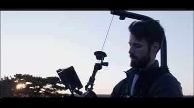 a man with a camera attached to his shoulder