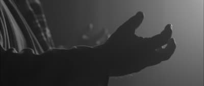 a person holding their hand up in the air