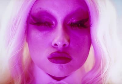 a close up of a person with purple makeup