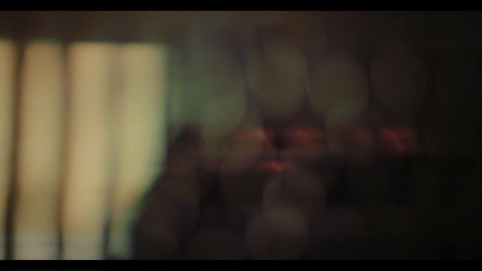 a blurry photo of a window with blinds