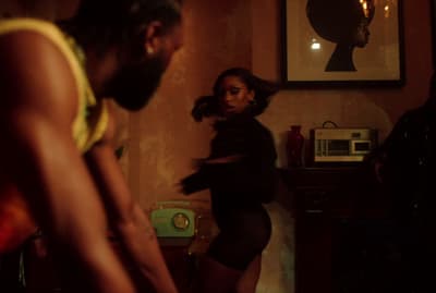 a woman standing in a room next to a man
