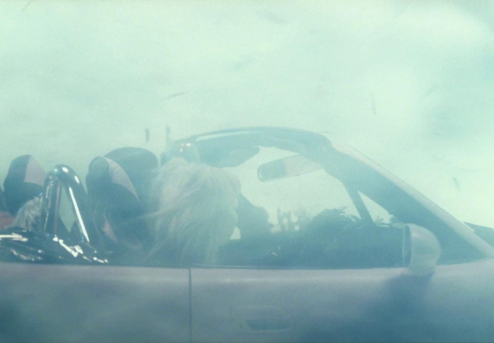 a dog is sitting in the driver's seat of a car