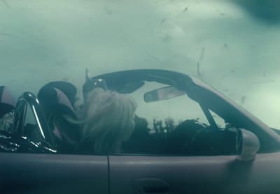 a woman sitting in the driver's seat of a car