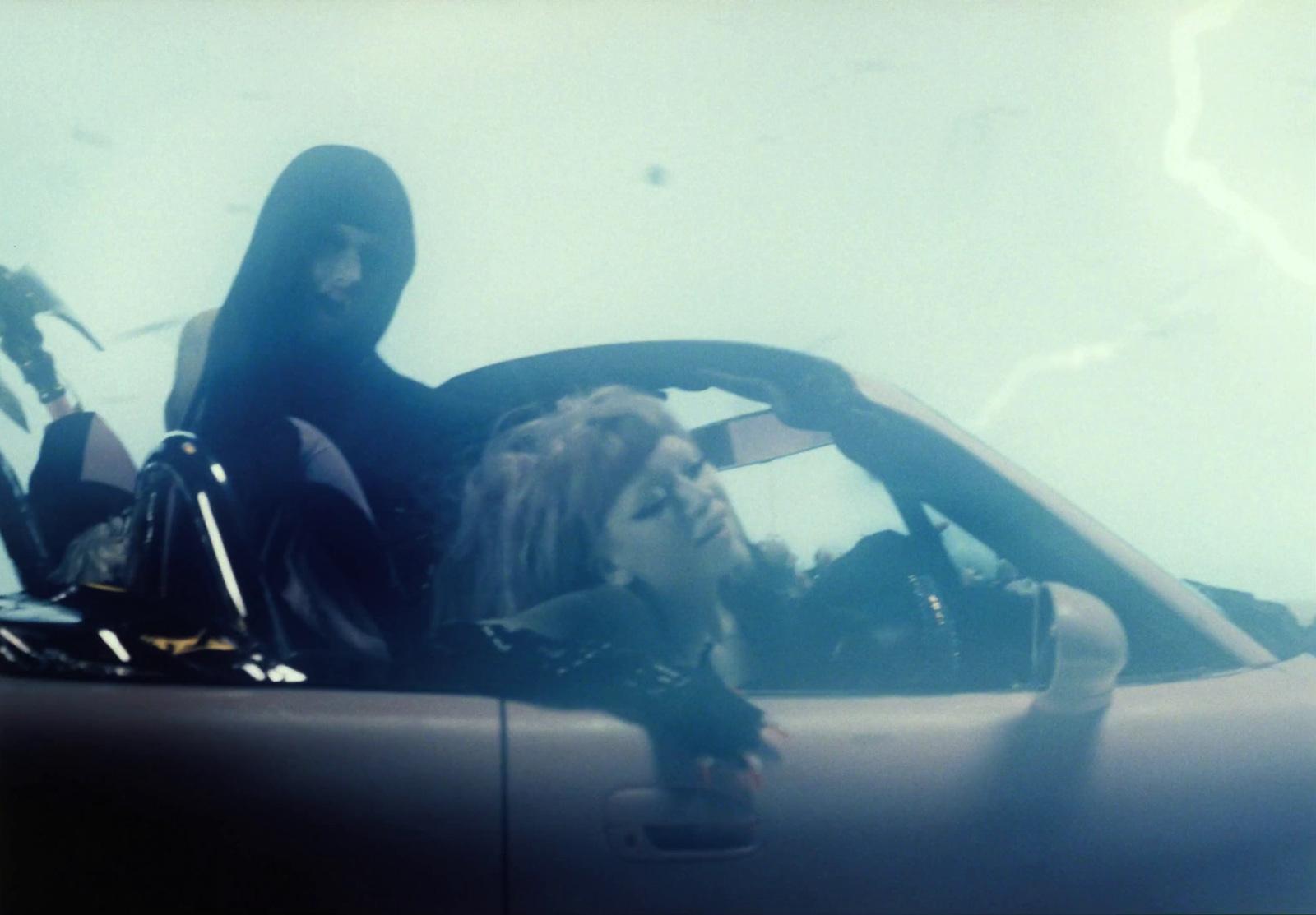 a woman sitting in the driver's seat of a car