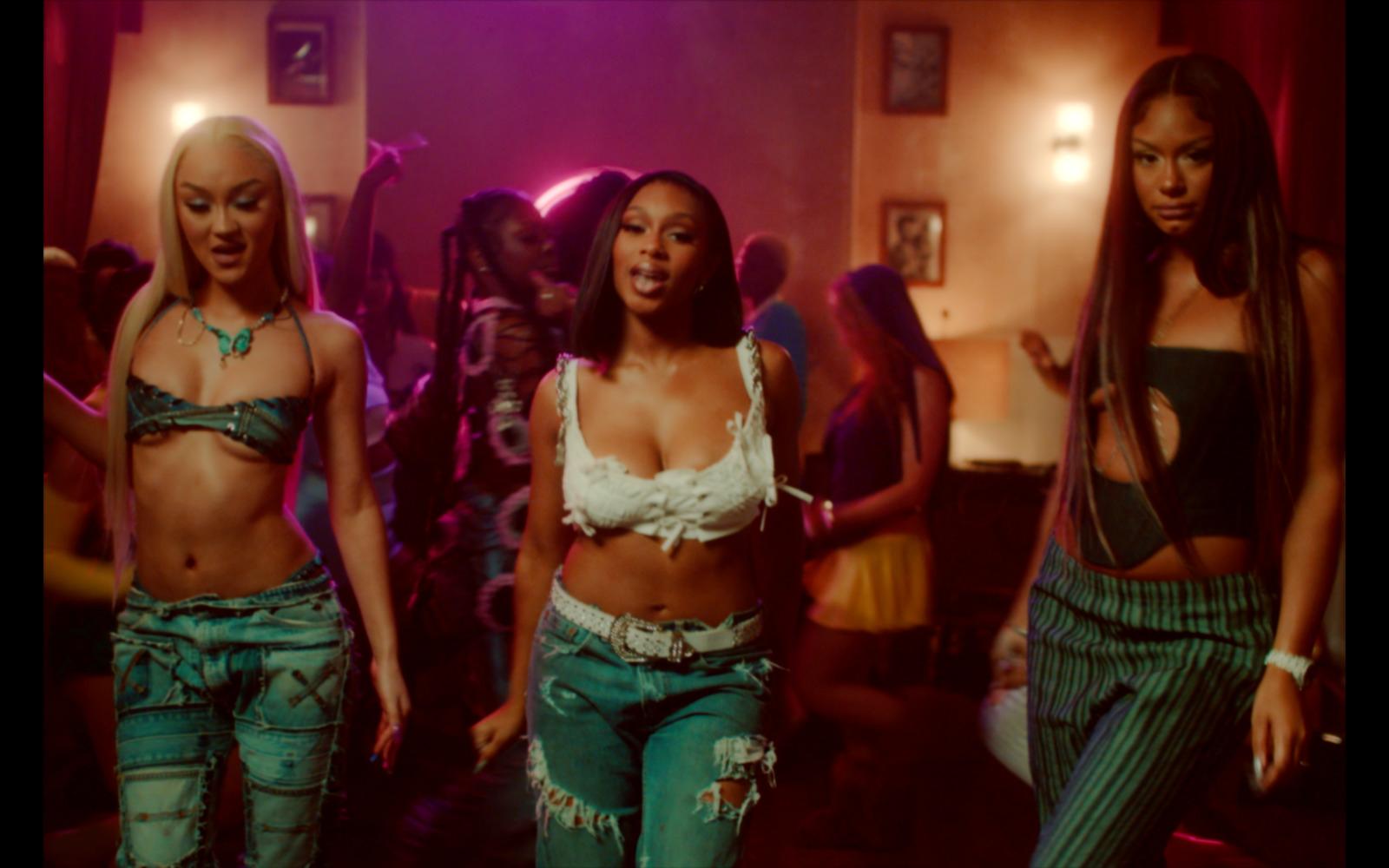 a group of women standing next to each other in a room