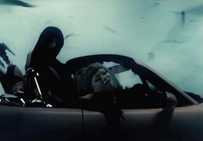 a woman sitting in the back of a car
