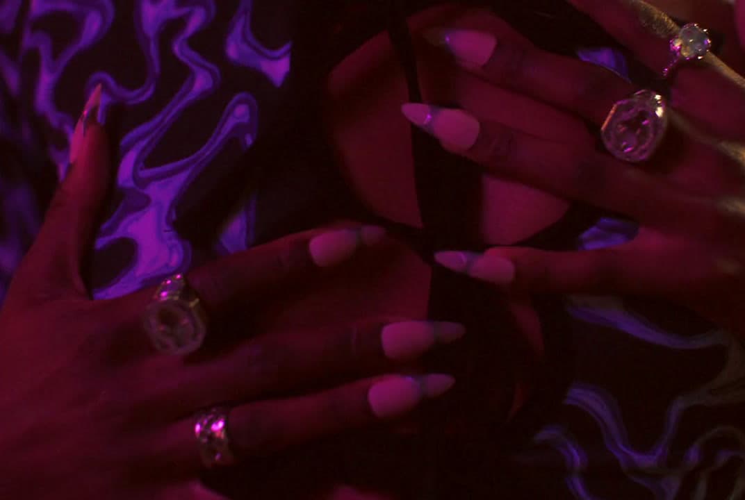 a close up of a person's hands with manicured nails