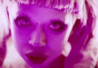 a close up of a person with purple makeup