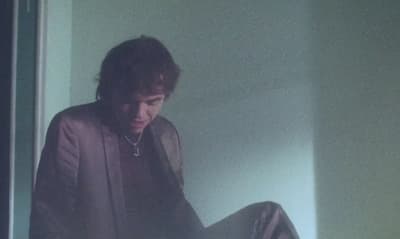 a man sitting on the floor in a room