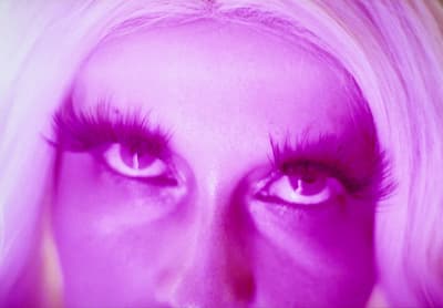 a close up of a woman's face with long eyelashes