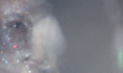 a close up of a person's face with a blurry background