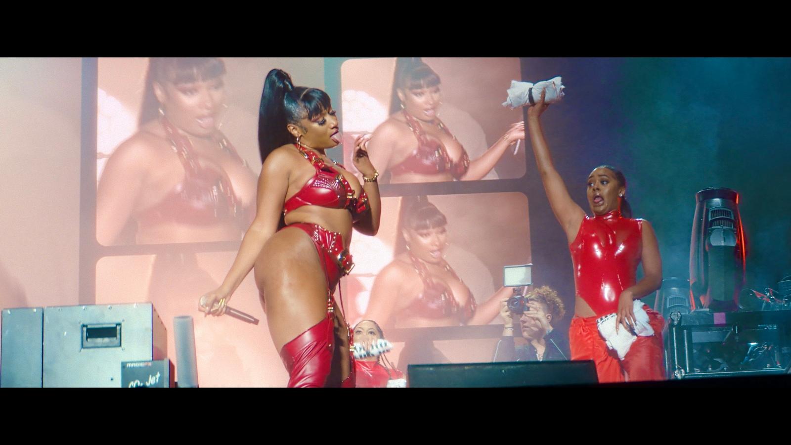 a couple of women standing on top of a stage