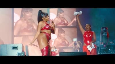 a couple of women standing on top of a stage