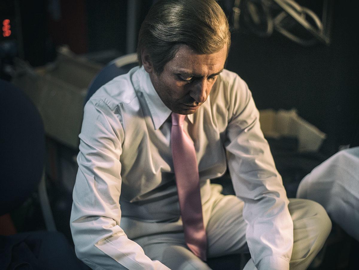 a man in a white shirt and pink tie