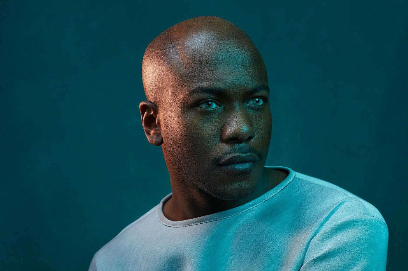 a man with a bald head and blue eyes