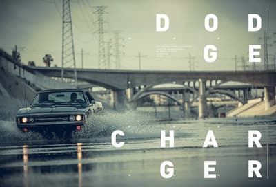 a car driving through a flooded street with a bridge in the background