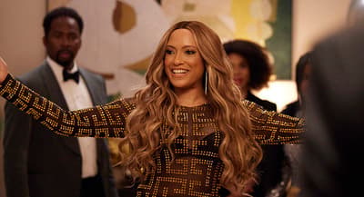 a woman in a black and gold dress and a man in a tuxedo