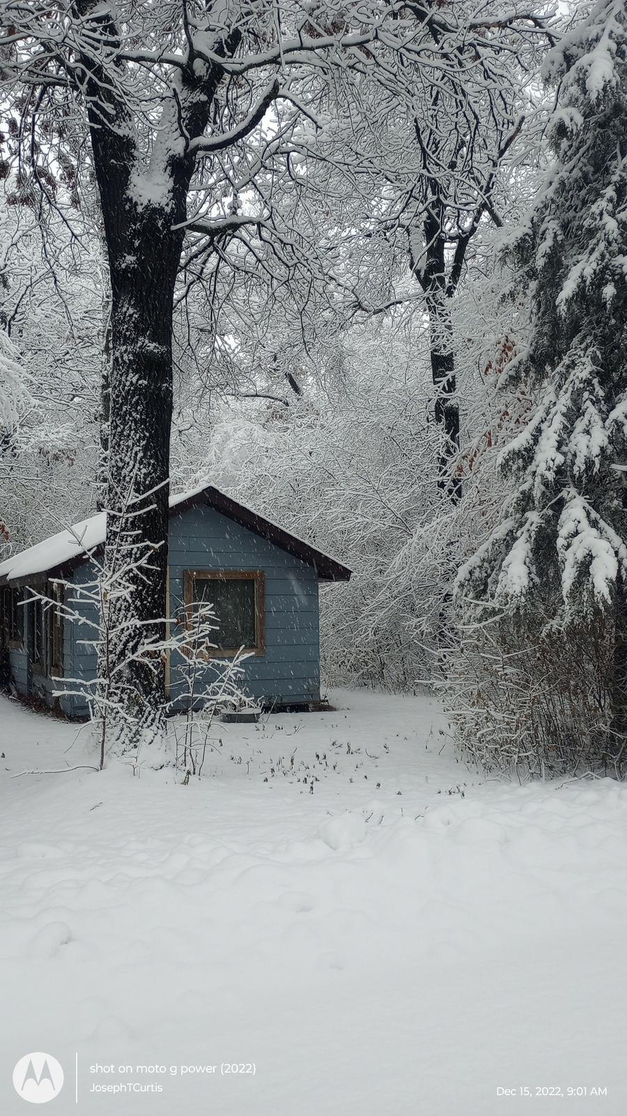 an aerial view of a house in the snow