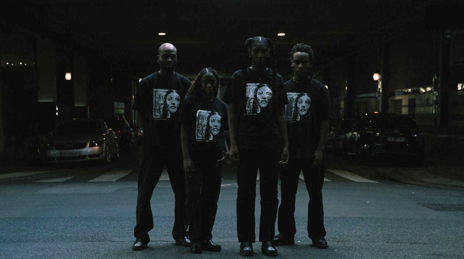 a group of people standing in the middle of a street