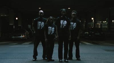 a group of people standing in the middle of a street