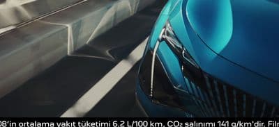 a blue car driving down a highway next to another car