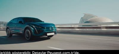 a blue suv driving down a highway next to a bridge