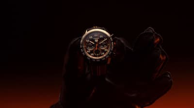 a person holding a watch in their hand