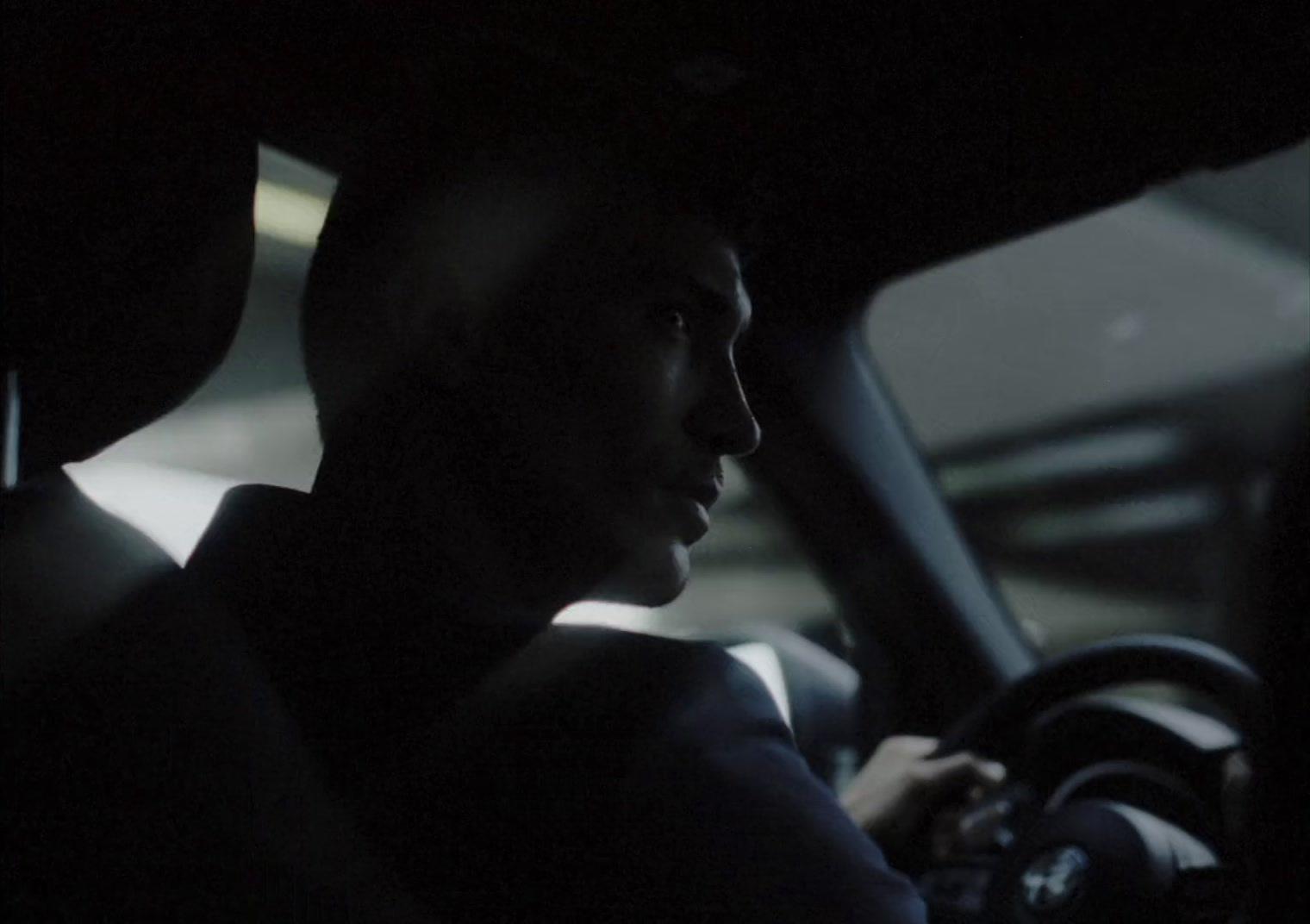 a man driving a car in the dark