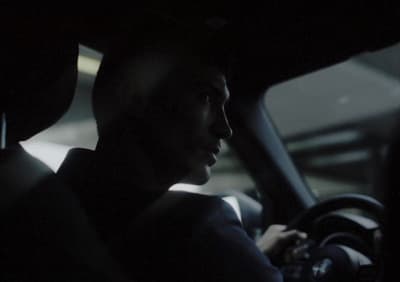 a man driving a car in the dark
