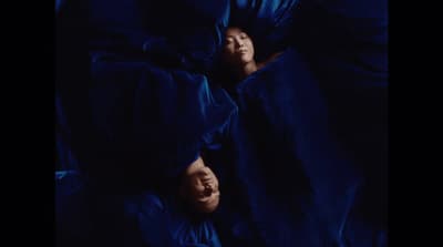 a couple of people that are laying in a bed