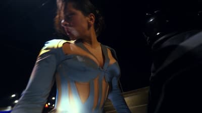 a woman in a body suit standing next to a man