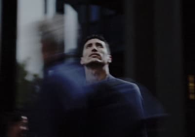 a man standing in front of a tall building