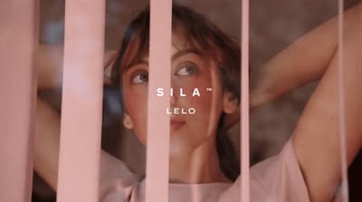 a woman behind bars with the words sila on it