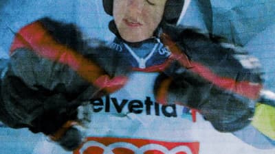 a young man wearing a helmet and gloves