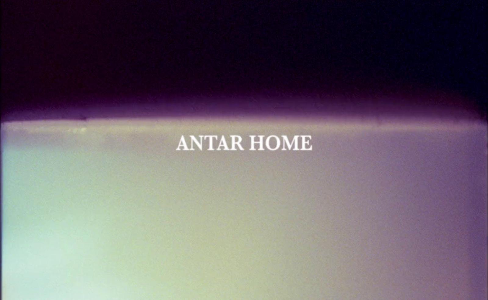 a blurry photo of a toilet with the words antar home on it