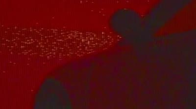 a man standing in front of a red background