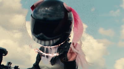 a person wearing a helmet and a pink scarf