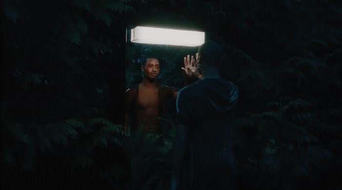 a man standing in front of a mirror in the dark