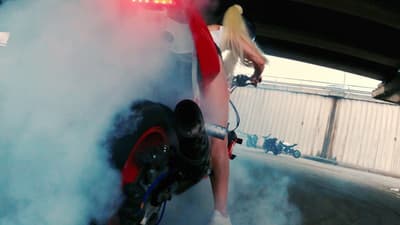 a person riding a motorcycle with a lot of smoke coming out of it