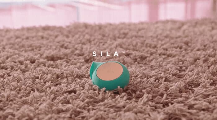 a pair of green shoes sitting on top of a carpet