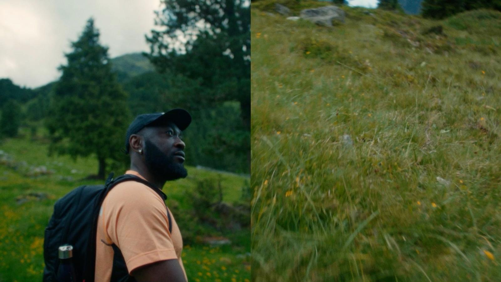 a man with a backpack standing in a field
