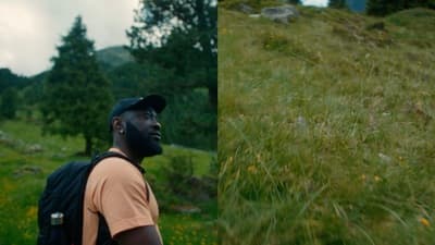 a man with a backpack standing in a field