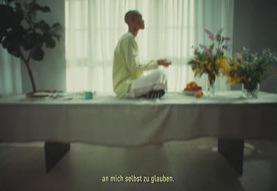 a man sitting on a table in front of a window