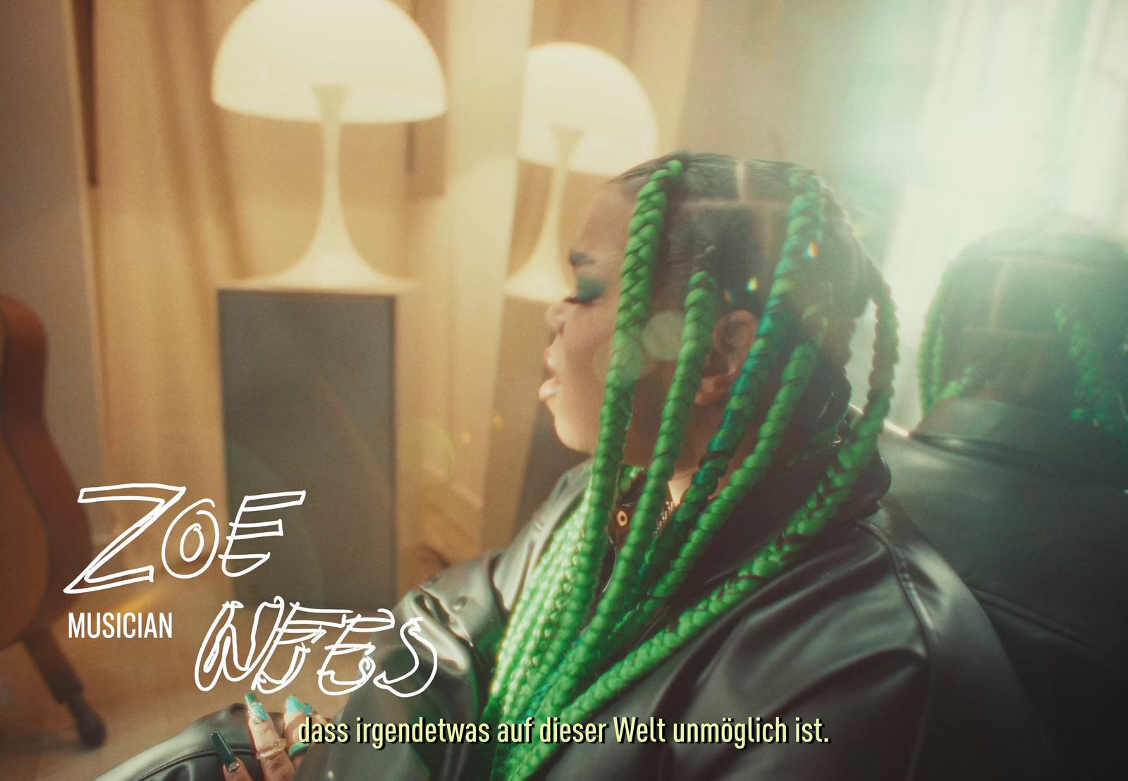 a woman with green dreadlocks in a room