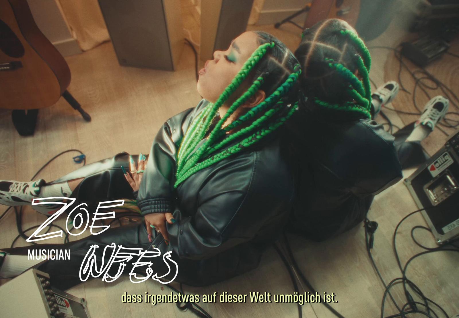 a man with dreadlocks sitting in a chair