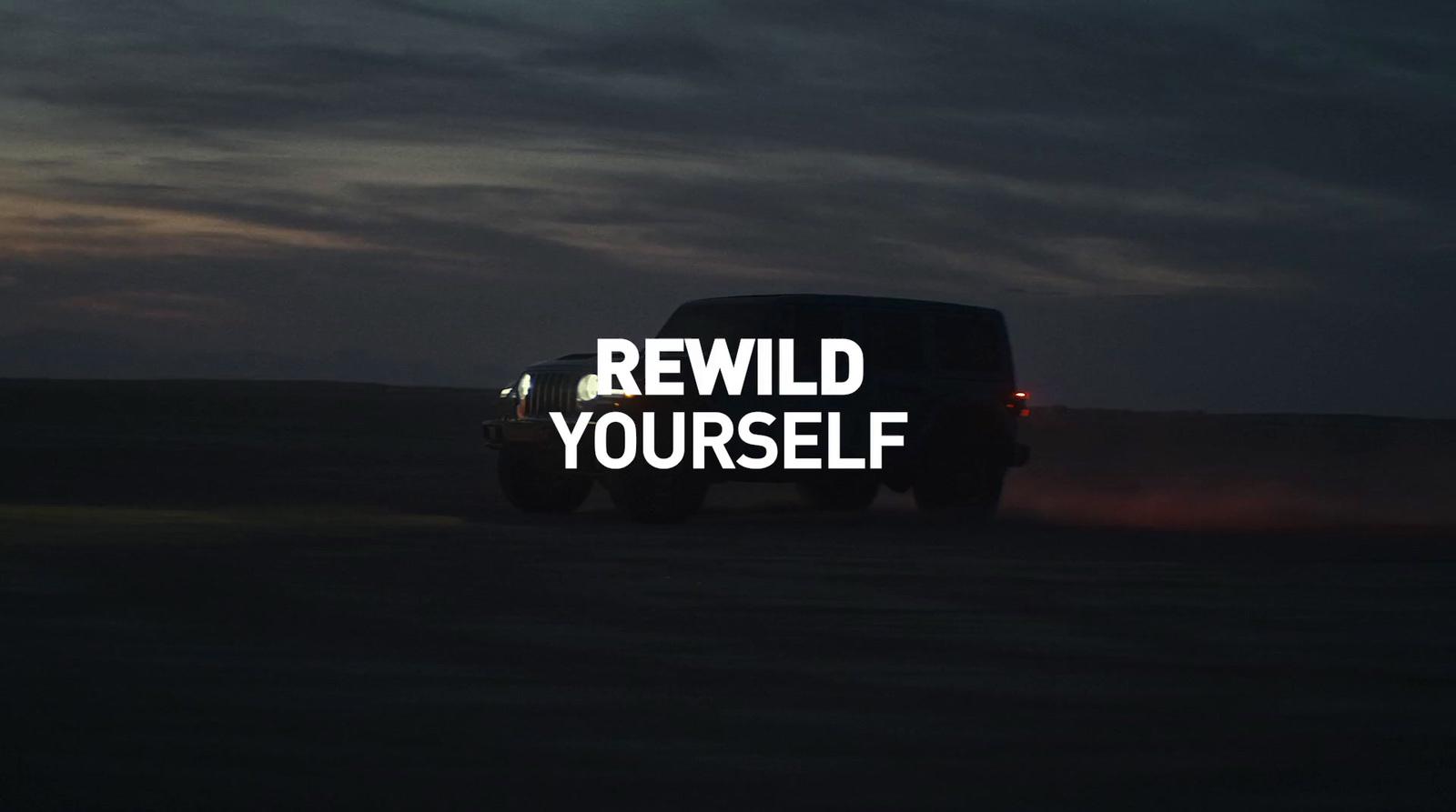 a truck driving down a road with the words re wild yourself written on it