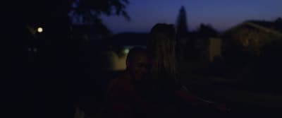 a couple of people that are standing in the dark
