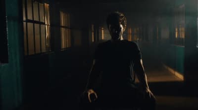 a man in a dark room with a creepy look on his face