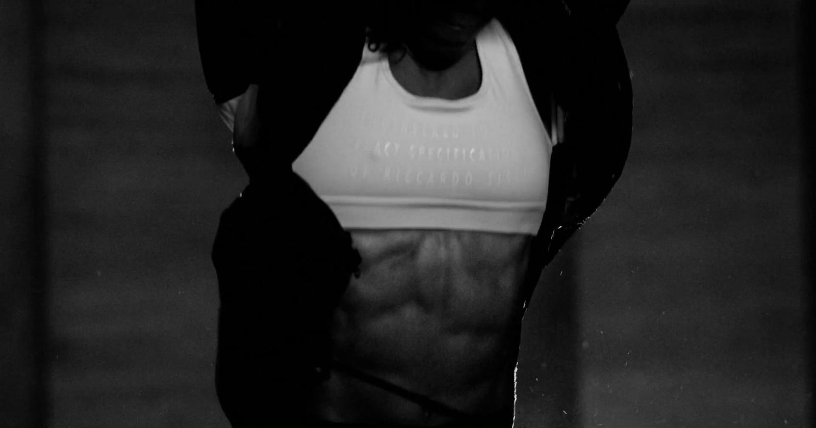 a black and white photo of a woman in a sports bra